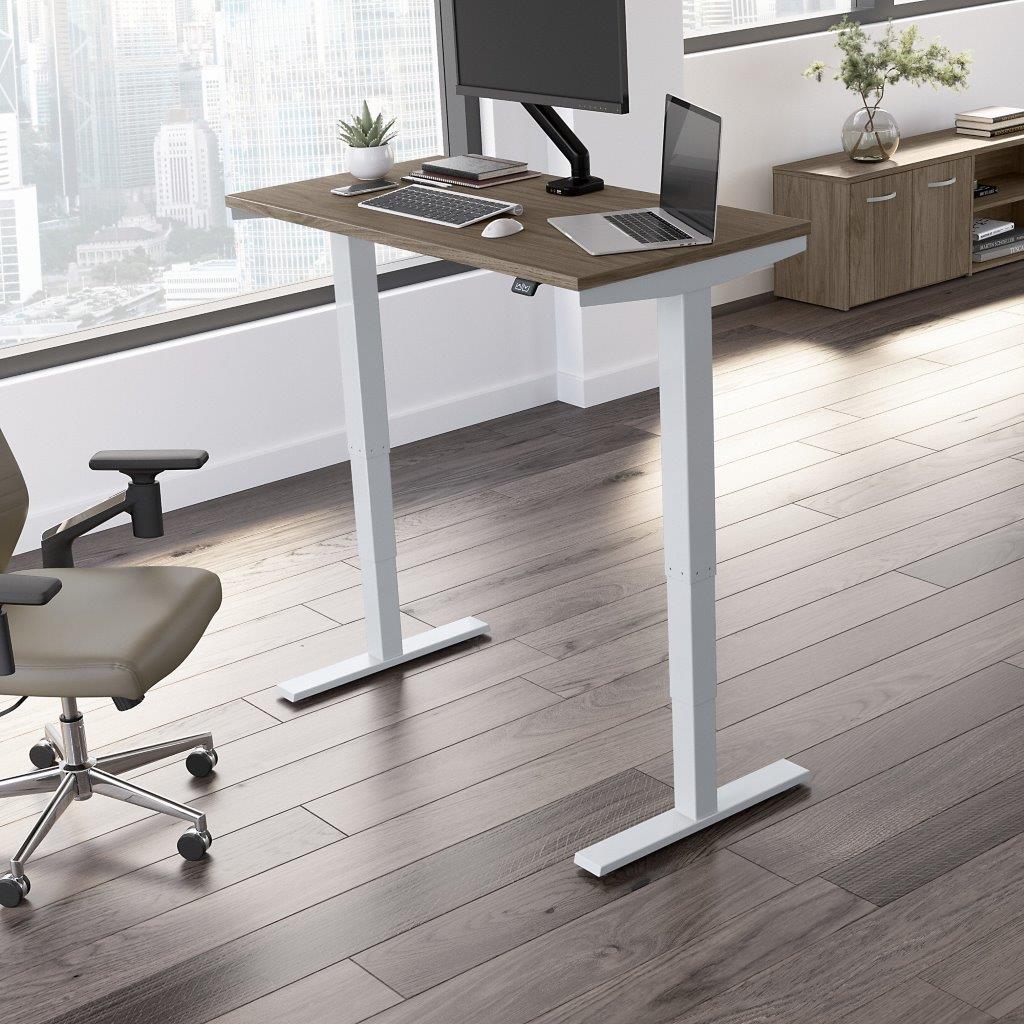 https://cdn.1stopbedrooms.com/media/catalog/product/m/o/move-40-series-by-bush-business-furniture-48w-x-24d-electric-height-adjustable-standing-desk-in-modern-hickory_qb13408987.jpg