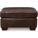 The appearance of Santorine Ottoman In Dark Brown designed by Signature Design by Ashley in the modern / contemporary interior design. This dark brown piece of furniture  was selected by 1StopBedrooms from Santorine Collection to add a touch of cosiness and style into your home. Sku: 2170614. Material: Faux Leather.