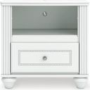 The appearance of Trindura Nightstand In White designed by Signature Design by Ashley in the traditional interior design. This white piece of furniture was selected by 1StopBedrooms from Trindura Collection to add a touch of cosiness and style into your home. Sku: NCB1819-91. Material: Wood.