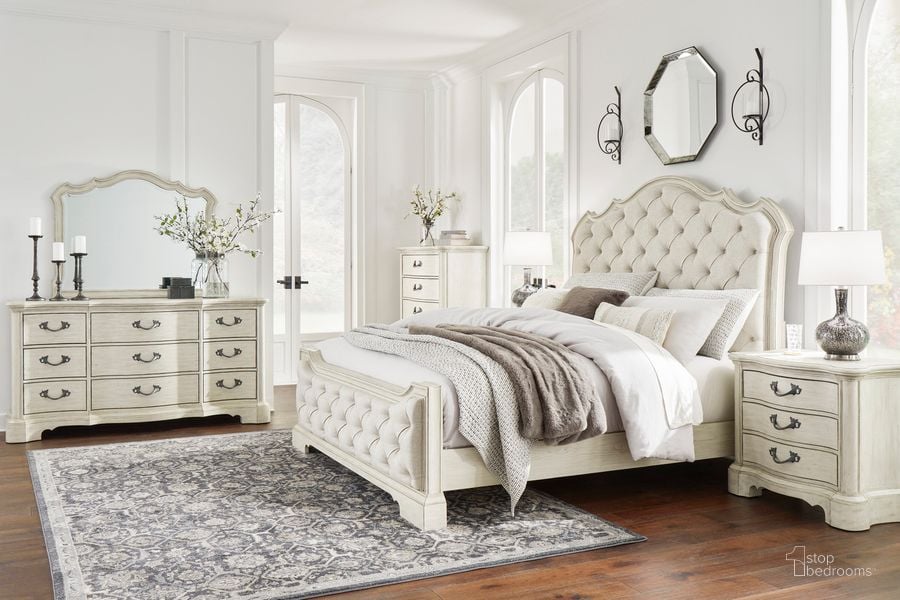 The appearance of Arlendyne Antiqued White Painted Upholstered Panel Bedroom Set designed by Signature Design by Ashley in the traditional interior design. This white piece of furniture  was selected by 1StopBedrooms from Arlendyne Collection to add a touch of cosiness and style into your home. Sku: B980-54;B980-57;B980-97;B980-93. Material: Wood. Product Type: Panel Bed. Bed Size: Queen. Image1
