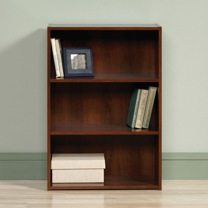 The appearance of Beginnings 3-Shelf Bookcase In Brook Cherry designed by Sauder in the transitional interior design. This brook cherry piece of furniture  was selected by 1StopBedrooms from Beginnings Collection to add a touch of cosiness and style into your home. Sku: 416438. Product Type: Bookcase. Material: Engineered Wood. Image1