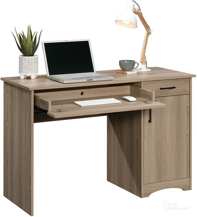 The appearance of Beginnings Computer Desk In Summer Oak designed by Sauder in the transitional interior design. This summer oak piece of furniture  was selected by 1StopBedrooms from Beginnings Collection to add a touch of cosiness and style into your home. Sku: 424256. Product Type: Computer Desk. Material: Engineered Wood. Image1