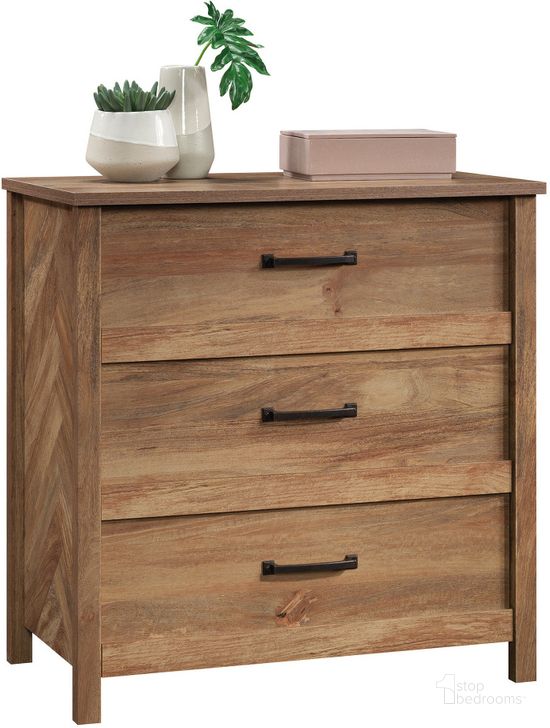 The appearance of Cannery Bridge 3-Drawer Chest In Sindoori Mango designed by Sauder in the country / farmhouse interior design. This sindoori mango piece of furniture  was selected by 1StopBedrooms from Cannery Bridge Collection to add a touch of cosiness and style into your home. Sku: 431752. Product Type: Chest. Material: Engineered Wood. Image1