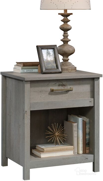 The appearance of Cannery Bridge Night Stand In Mystic Oak designed by Sauder in the country / farmhouse interior design. This mystic oak piece of furniture  was selected by 1StopBedrooms from Cannery Bridge Collection to add a touch of cosiness and style into your home. Sku: 422871. Product Type: Nightstand. Material: Engineered Wood. Image1