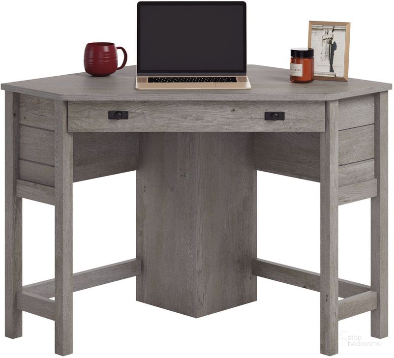 The appearance of Cottage Road Corner Computer Desk In Mystic Oak designed by Sauder in the country / farmhouse interior design. This mystic oak piece of furniture  was selected by 1StopBedrooms from Cottage Road Collection to add a touch of cosiness and style into your home. Sku: 430060. Product Type: Computer Desk. Material: Engineered Wood. Image1