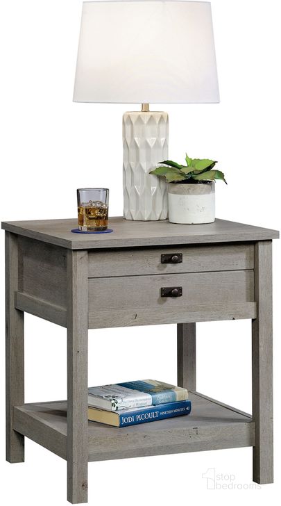 The appearance of Cottage Road Night Stand In Mystic Oak designed by Sauder in the country / farmhouse interior design. This mystic oak piece of furniture  was selected by 1StopBedrooms from Cottage Road Collection to add a touch of cosiness and style into your home. Sku: 423328. Product Type: Nightstand. Material: Engineered Wood. Image1