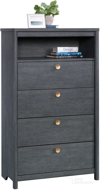 The appearance of Dover Edge Chest Of Drawers In Denim Oak designed by Sauder in the transitional interior design. This denim oak piece of furniture  was selected by 1StopBedrooms from Dover Edge Collection to add a touch of cosiness and style into your home. Sku: 433516. Product Type: Chest. Image1