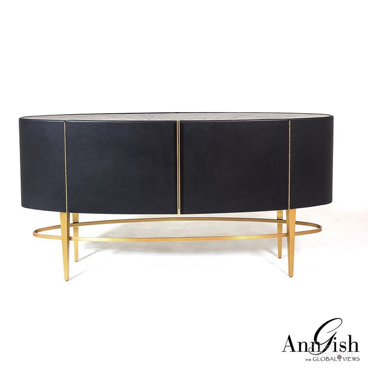 The appearance of Ellipse Sideboard In Ebony designed by Global Views in the modern / contemporary interior design. This black piece of furniture  was selected by 1StopBedrooms from Ellipse Collection to add a touch of cosiness and style into your home. Sku: AG2.20017. Material: Leather. Product Type: Sideboard. Image1