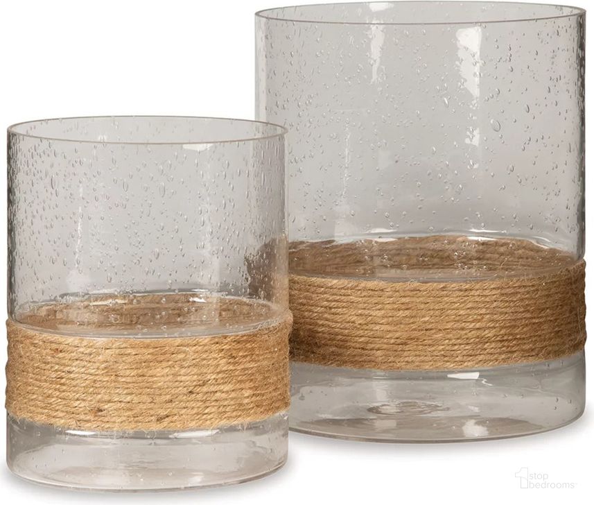 The appearance of Eudocia Clear Candle Holder Set of 2 designed by Signature Design by Ashley in the transitional interior design. This clear piece of furniture  was selected by 1StopBedrooms from Eudocia Collection to add a touch of cosiness and style into your home. Sku: A2000456. Product Type: Candle Holder. Image1