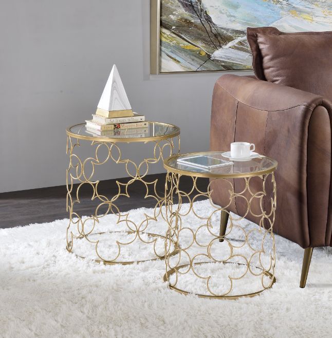 The appearance of Flowie Nesting Table Set In Clear Glass Top And Gold designed by ACME in the modern / contemporary interior design. This gold piece of furniture  was selected by 1StopBedrooms from Flowie Collection to add a touch of cosiness and style into your home. Sku: 82342. Material: Metal. Product Type: Nesting Table. Image1