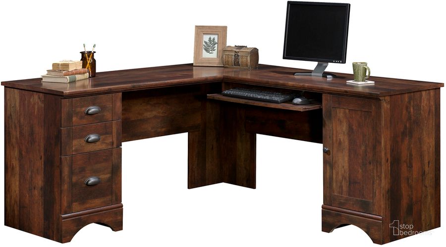 The appearance of Harbor View Corner Computer Desk In Curado Cherry designed by Sauder in the country / farmhouse interior design. This curado cherry piece of furniture  was selected by 1StopBedrooms from Harbor View Collection to add a touch of cosiness and style into your home. Sku: 420474. Product Type: Computer Desk. Material: Engineered Wood. Image1
