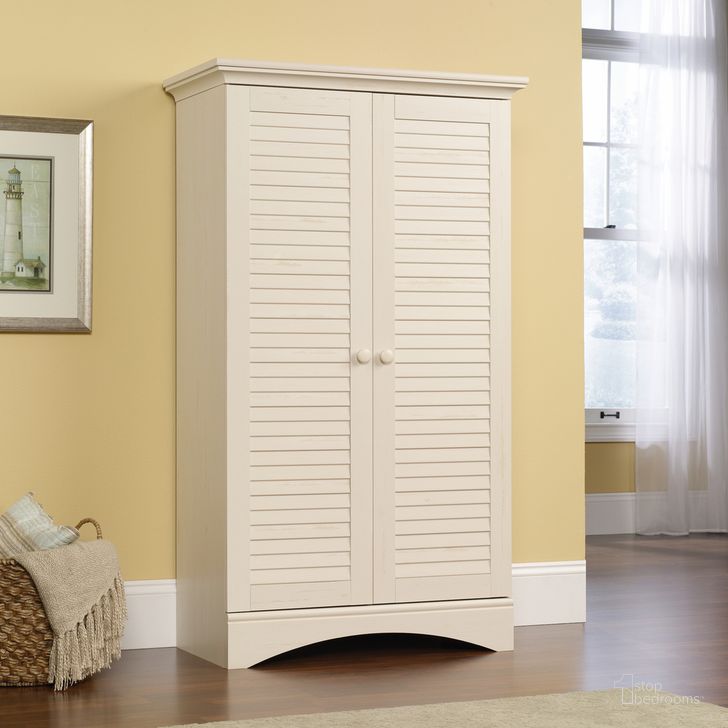 The appearance of Harbor View Storage Cabinet In Antiqued White designed by Sauder in the country / farmhouse interior design. This antiqued white piece of furniture  was selected by 1StopBedrooms from Harbor View Collection to add a touch of cosiness and style into your home. Sku: 400742. Product Type: Storage Cabinet. Material: Engineered Wood. Image1