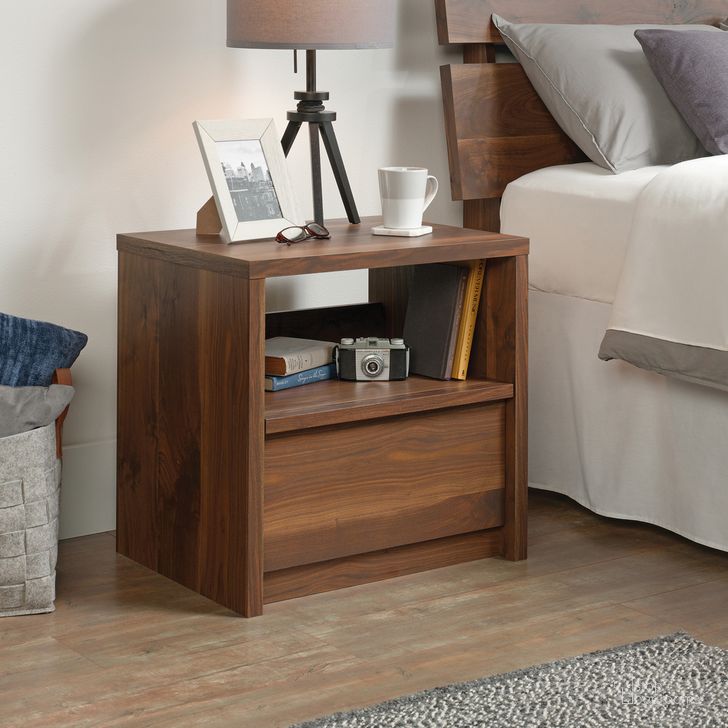 The appearance of Harvey Park Night Stand In Grand Walnut designed by Sauder in the modern / contemporary interior design. This grand walnut piece of furniture  was selected by 1StopBedrooms from Harvey Park Collection to add a touch of cosiness and style into your home. Sku: 420944. Product Type: Nightstand. Material: Engineered Wood. Image1