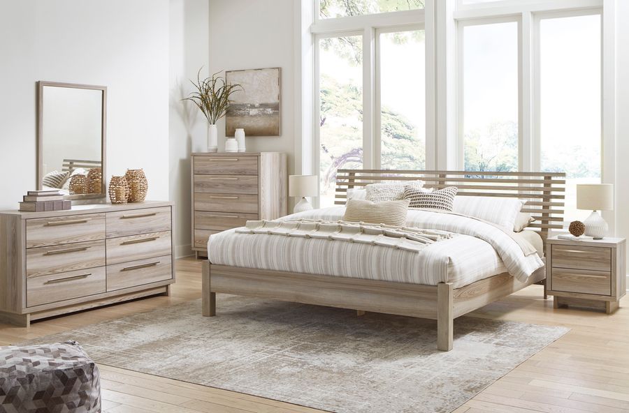The appearance of Hasbrick Tan Slat Panel Bedroom Set with Footboard designed by Signature Design by Ashley in the transitional interior design. This tan piece of furniture  was selected by 1StopBedrooms from Hasbrick Collection to add a touch of cosiness and style into your home. Sku: B100-13;B2075-154;B2075-157;B2075-92. Material: Wood. Product Type: Bedroom Set. Bed Size: Queen. Image1