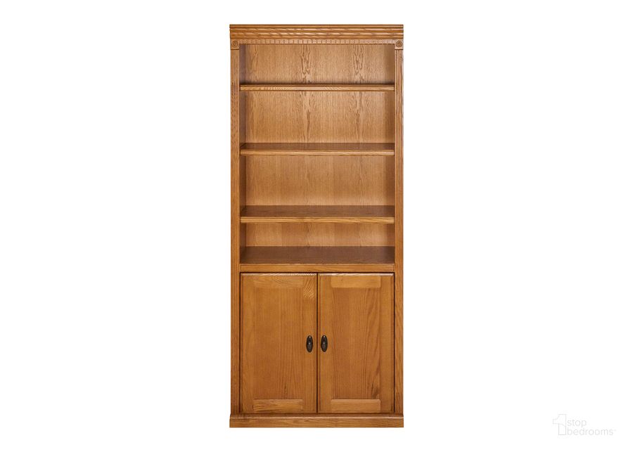 The appearance of Huntington Oxford Wood Bookcase with Doors In Wheat designed by Martin Furniture in the traditional interior design. This wheat piece of furniture  was selected by 1StopBedrooms from Huntington Collection to add a touch of cosiness and style into your home. Sku: HO3072D/W. Material: Wood. Product Type: Bookcase. Image1