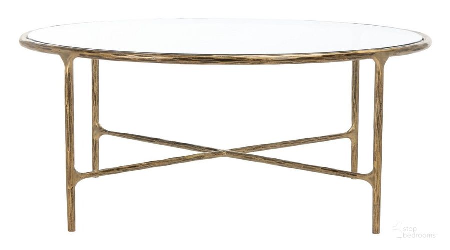 The appearance of Jessa Round Metal Coffee Table In Brass designed by Safavieh Couture in the glam interior design. This brass piece of furniture  was selected by 1StopBedrooms from Jessa Collection to add a touch of cosiness and style into your home. Sku: SFV9501A. Material: Metal. Product Type: Coffee Table. Image1