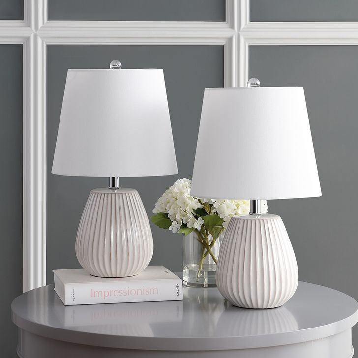 The appearance of Kole White Table Lamp Set of 2 designed by Safavieh in the modern / contemporary interior design. This white piece of furniture  was selected by 1StopBedrooms from Safavieh TBL Collection to add a touch of cosiness and style into your home. Sku: TBL4139A-SET2. Material: Chrome. Product Type: Table Lamp. Image1