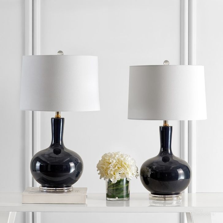 The appearance of Nilla Navy and Clear Table Lamp Set of 2 designed by Safavieh in the modern / contemporary interior design. This navy piece of furniture  was selected by 1StopBedrooms from Nilla Collection to add a touch of cosiness and style into your home. Sku: TBL4224B-SET2. Product Type: Table Lamp. Image1