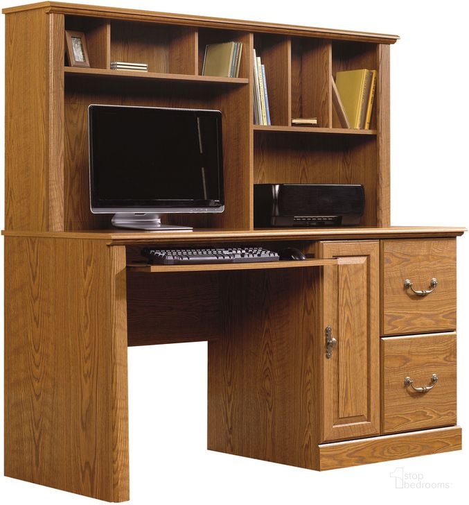 The appearance of Orchard Hills Computer Desk With Hutch In Carolina Oak designed by Sauder in the country / farmhouse interior design. This carolina oak piece of furniture  was selected by 1StopBedrooms from Orchard Hills Collection to add a touch of cosiness and style into your home. Sku: 401354. Product Type: Computer Desk. Material: Engineered Wood. Image1