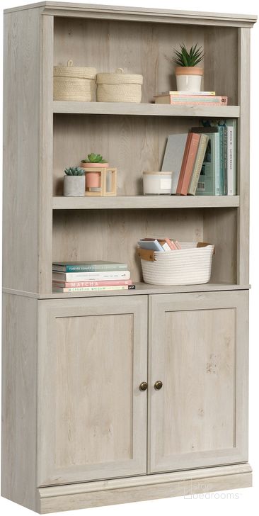 The appearance of Sauder Select Bookcase With Doors In Chalked Chestnut designed by Sauder in the transitional interior design. This chalked chestnut piece of furniture  was selected by 1StopBedrooms from Sauder Select Collection to add a touch of cosiness and style into your home. Sku: 426310. Product Type: Bookcase. Material: Engineered Wood. Image1