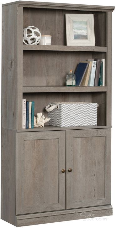 The appearance of Sauder Select Bookcase With Doors In Mystic Oak designed by Sauder in the transitional interior design. This mystic oak piece of furniture  was selected by 1StopBedrooms from Sauder Select Collection to add a touch of cosiness and style into your home. Sku: 426418. Product Type: Bookcase. Material: Engineered Wood. Image1