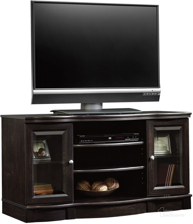 The appearance of Sauder Select Tv Stand In Estate Black designed by Sauder in the traditional interior design. This estate black piece of furniture  was selected by 1StopBedrooms from Sauder Select Collection to add a touch of cosiness and style into your home. Sku: 412871. Product Type: TV Stand. Material: Engineered Wood. Image1