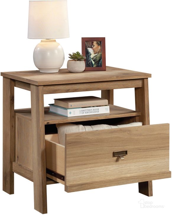 The appearance of Trestle Night Stand In Timber Oak designed by Sauder in the modern / contemporary interior design. This timber oak piece of furniture  was selected by 1StopBedrooms from Trestle Collection to add a touch of cosiness and style into your home. Sku: 433917. Product Type: Nightstand. Material: Engineered Wood. Image1