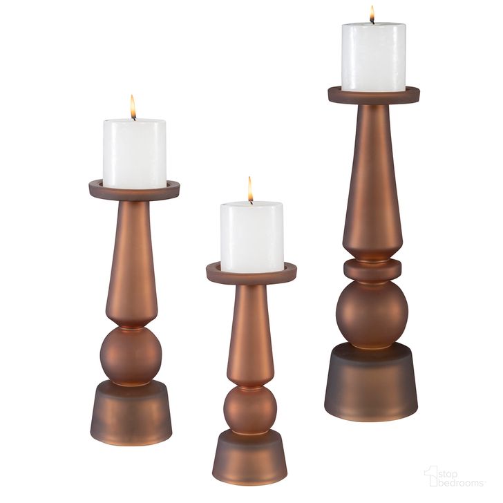 The appearance of Uttermost Cassiopeia Butter Rum Glass Candleholders Set Of 3 designed by Uttermost in the traditional interior design. This brown piece of furniture  was selected by 1StopBedrooms from Cassiopeia Collection to add a touch of cosiness and style into your home. Sku: 18045. Material: Glass. Product Type: Candle Holder. Image1