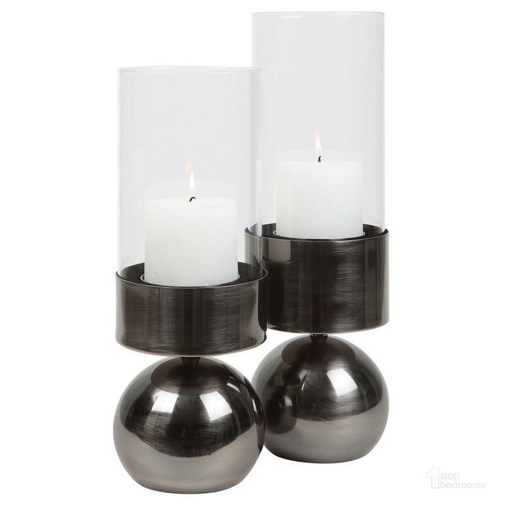 The appearance of Uttermost Tilston Gunmetal Candleholders Set Of 2 designed by Uttermost in the modern / contemporary interior design. This gray piece of furniture  was selected by 1StopBedrooms from Tilston Collection to add a touch of cosiness and style into your home. Sku: 18050. Product Type: Candle Holder. Material: Iron. Image1