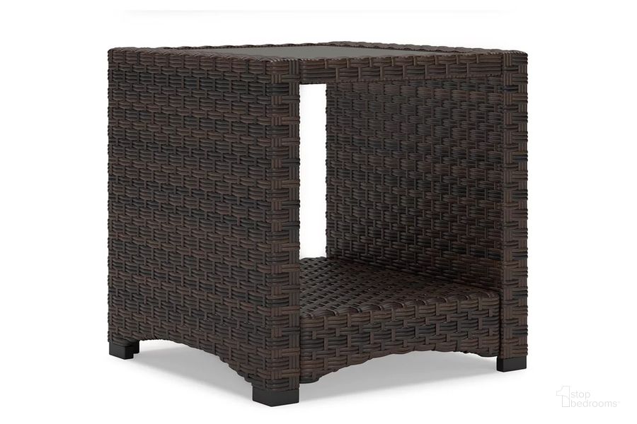The appearance of Windglow Outdoor End Table In Brown designed by Signature Design by Ashley in the transitional interior design. This brown piece of furniture  was selected by 1StopBedrooms from Windglow Collection to add a touch of cosiness and style into your home. Sku: P340-702. Product Type: Outdoor Table. Material: Resin. Image1