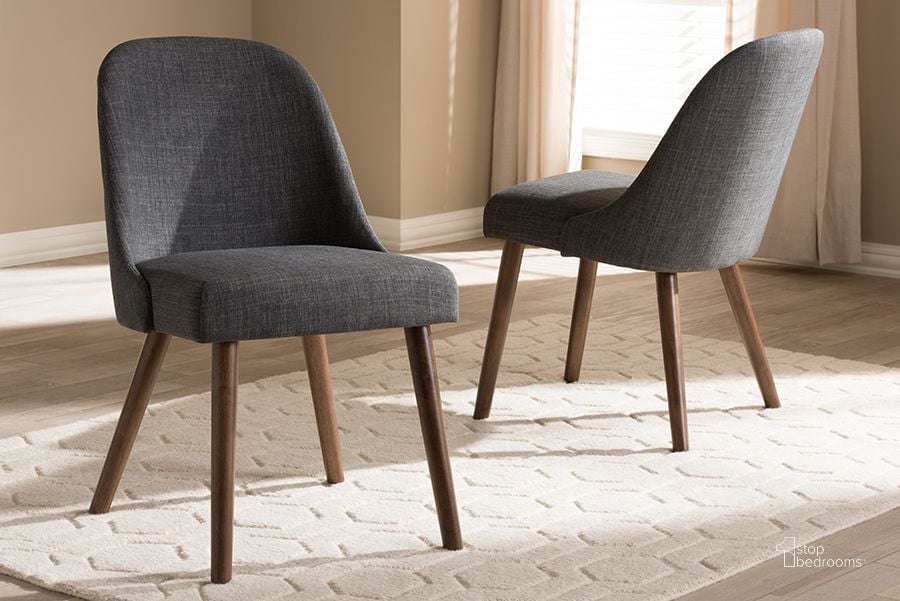 The appearance of Baxton Studio Cody Mid-Century Modern Dark Grey Fabric Upholstered Walnut Finished Wood Dining Chair (Set Of 2) designed by Baxton Studio in the transitional interior design. This dark grey piece of furniture  was selected by 1StopBedrooms from Cody Collection to add a touch of cosiness and style into your home. Sku: Cody-Dark Grey-DC. Material: Fabric. Product Type: Dining Chair. Image1