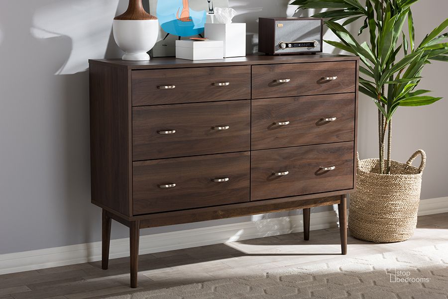 The appearance of Baxton Studio Disa Mid-Century Modern Walnut Brown Finished 6-Drawer Dresser designed by Baxton Studio in the transitional interior design. This brown piece of furniture  was selected by 1StopBedrooms from Disa Collection to add a touch of cosiness and style into your home. Sku: DC 6311-00-Brown-Chest. Product Type: Chest. Material: MDF. Image1
