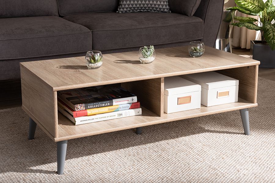 The appearance of Baxton Studio Pierre Mid-Century Modern Oak And Light Grey Finished Wood Coffee Table designed by Baxton Studio in the transitional interior design. This oak piece of furniture  was selected by 1StopBedrooms from Pierre Collection to add a touch of cosiness and style into your home. Sku: SECFT3001-Hana Oak/Light Grey-CT. Product Type: Coffee Table. Material: MDF. Image1