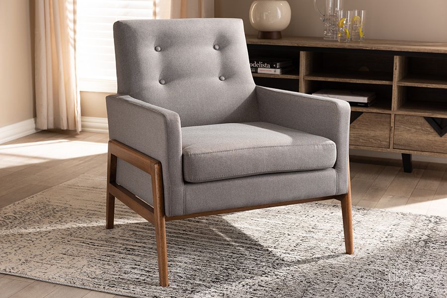 The appearance of Baxton Studio Perris Mid-Century Modern Grey Fabric Upholstered Walnut Wood Lounge Chair designed by Baxton Studio in the transitional interior design. This grey piece of furniture  was selected by 1StopBedrooms from Perris Collection to add a touch of cosiness and style into your home. Sku: BBT8042-Grey-CC. Product Type: Lounge Chair. Material: Rubberwood. Image1