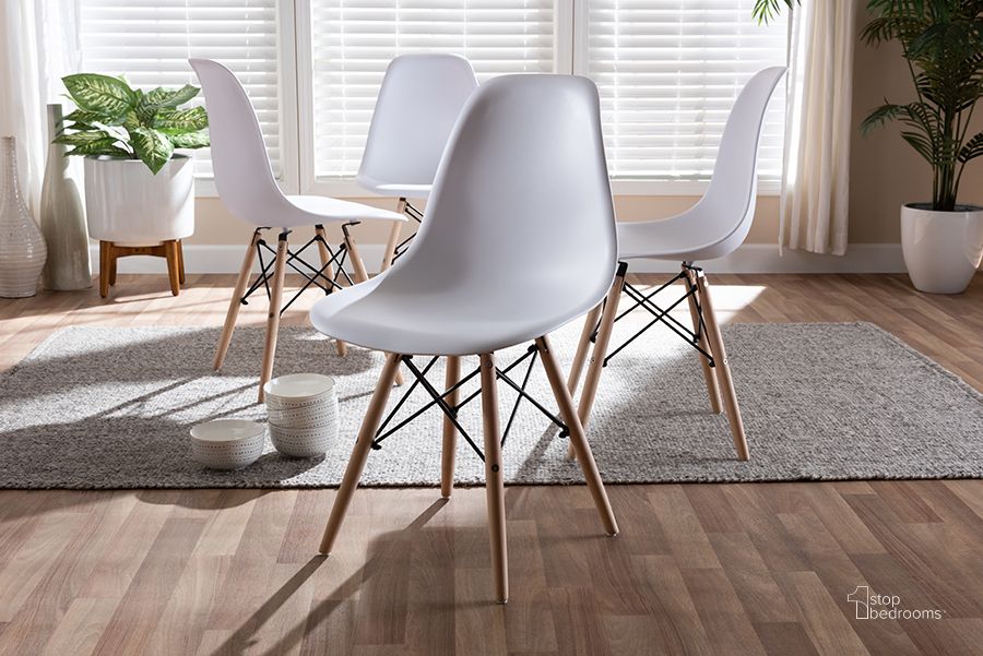 The appearance of Baxton Studio Sydnea Mid-Century Modern White Acrylic Brown Wood Finished Dining Chair (Set Of 4) designed by Baxton Studio in the transitional interior design. This white piece of furniture  was selected by 1StopBedrooms from Sydnea Collection to add a touch of cosiness and style into your home. Sku: 160529-White. Product Type: Dining Chair. Material: Acrylic. Image1