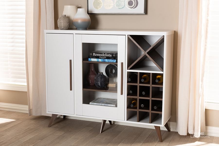 The appearance of Baxton Studio Pietro Mid-Century Modern White And Brown Finished Wine Cabinet designed by Baxton Studio in the transitional interior design. This white piece of furniture  was selected by 1StopBedrooms from Pietro Collection to add a touch of cosiness and style into your home. Sku: SEWC160071WI-White/Columbia. Product Type: Wine Cabinet. Material: MDF. Image1