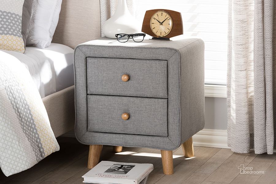 The appearance of Baxton Studio Jonesy Mid-Century Grey Fabric Upholstered 2-Drawer Nightstand designed by Baxton Studio in the transitional interior design. This grey piece of furniture  was selected by 1StopBedrooms from Jonesy Collection to add a touch of cosiness and style into your home. Sku: BBT3140-Grey-NS-800F. Material: Fabric. Product Type: Nightstand. Image1