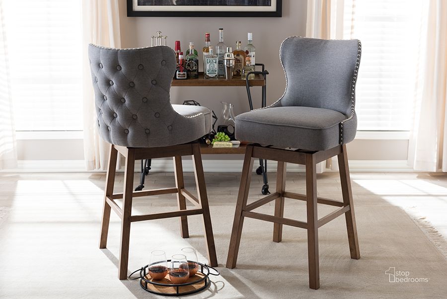 The appearance of Baxton Studio Gradisca Modern And Contemporary Brown Wood Finishing And Grey Fabric Button-Tufted Upholstered Swivel Barstool Set of 2 designed by Baxton Studio in the modern / contemporary interior design. This grey piece of furniture  was selected by 1StopBedrooms from Gradisca Collection to add a touch of cosiness and style into your home. Sku: BBT5246B-BS-Grey-XD45. Product Type: Barstool. Material: Rubberwood. Image1
