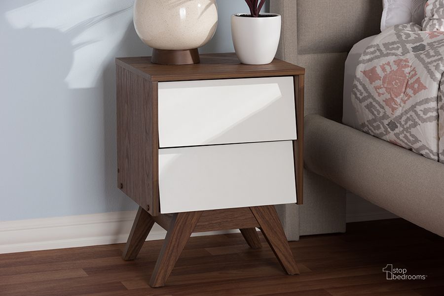 The appearance of Baxton Studio Hildon Mid-Century Modern White And Walnut Wood 2-Drawer Storage Nightstand designed by Baxton Studio in the transitional interior design. This white piece of furniture  was selected by 1StopBedrooms from Hildon Collection to add a touch of cosiness and style into your home. Sku: Hildon NS-Walnut/White. Product Type: Nightstand. Material: MDF. Image1