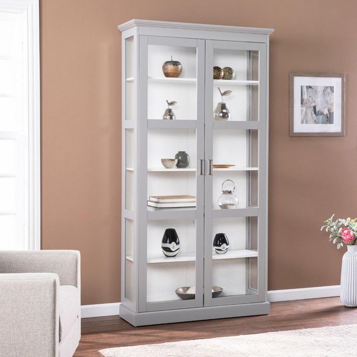 The appearance of Bardonton Tall Curio Cabinet designed by SEI Furniture in the transitional interior design. This grey piece of furniture  was selected by 1StopBedrooms from Bardonton Collection to add a touch of cosiness and style into your home. Sku: CM1103724. Material: Wood. Product Type: Curio Cabinet. Image1