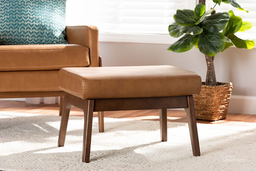 The appearance of Baxton Studio Bianca Mid-Century Modern Walnut Brown Finished Wood And Tan Faux Leather Effect Ottoman designed by Baxton Studio in the transitional interior design. This tan piece of furniture  was selected by 1StopBedrooms from Bianca Collection to add a touch of cosiness and style into your home. Sku: Bianca-Tan/Walnut Brown-Otto. Product Type: Ottoman. Material: Rubberwood. Image1