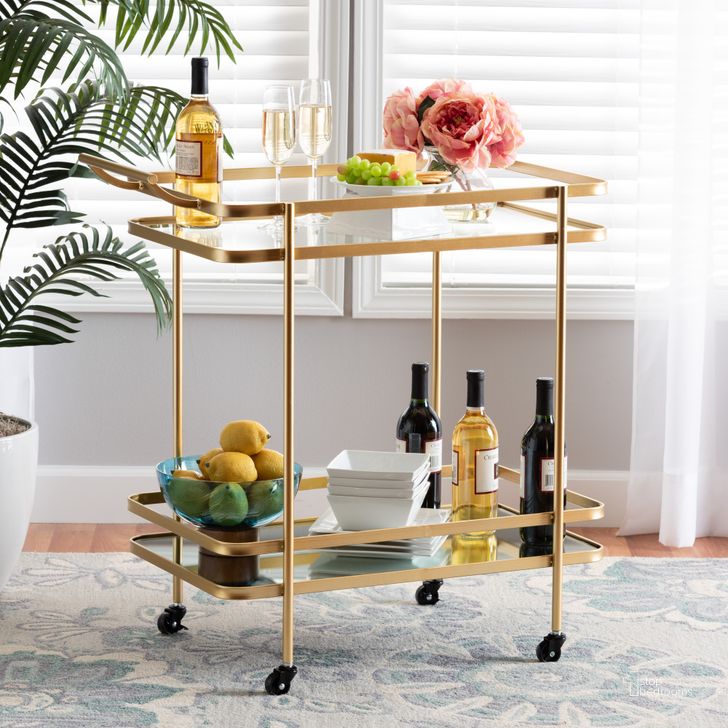The appearance of Baxton Studio Destin Modern and Contemporary Glam Brushed Gold Finished Metal and Mirrored Glass 2-Tier Mobile Wine Bar Cart designed by Baxton Studio in the glam interior design. This gold piece of furniture  was selected by 1StopBedrooms from Destin Collection to add a touch of cosiness and style into your home. Sku: JY20A263-Gold-Cart. Material: Metal. Product Type: Bar Cart. Image1