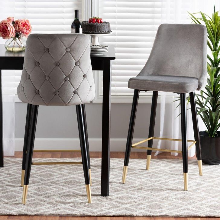 The appearance of Baxton Studio Giada Contemporary Glam and Luxe Grey Velvet Fabric and Dark Brown Finished Wood 2-Piece Bar Stool Set designed by Baxton Studio in the glam interior design. This black/gold piece of furniture  was selected by 1StopBedrooms from Giada Collection to add a touch of cosiness and style into your home. Sku: WI-12380-Grey Velvet-BS. Product Type: Barstool. Material: Plywood. Image1