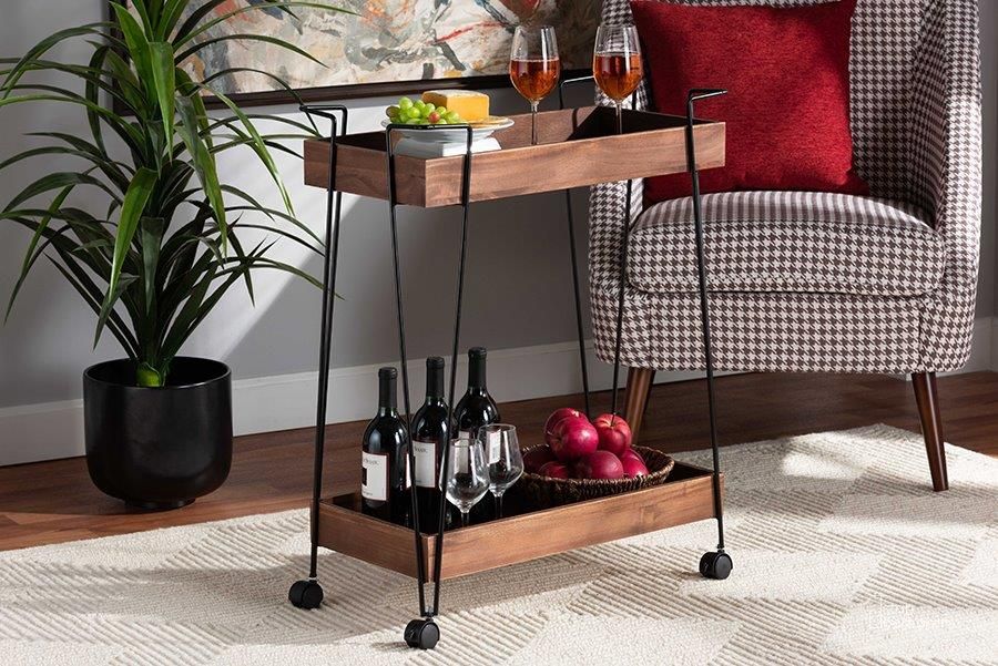The appearance of Baxton Studio Reynard Modern and Industrial Walnut Brown Finished Wood and Black Metal 2-Tier Wine Cart designed by Baxton Studio in the industrial interior design. This black walnut piece of furniture  was selected by 1StopBedrooms from Reynard Collection to add a touch of cosiness and style into your home. Sku: 6652-Metal-Cart. Material: Wood. Product Type: Bar Cart. Image1