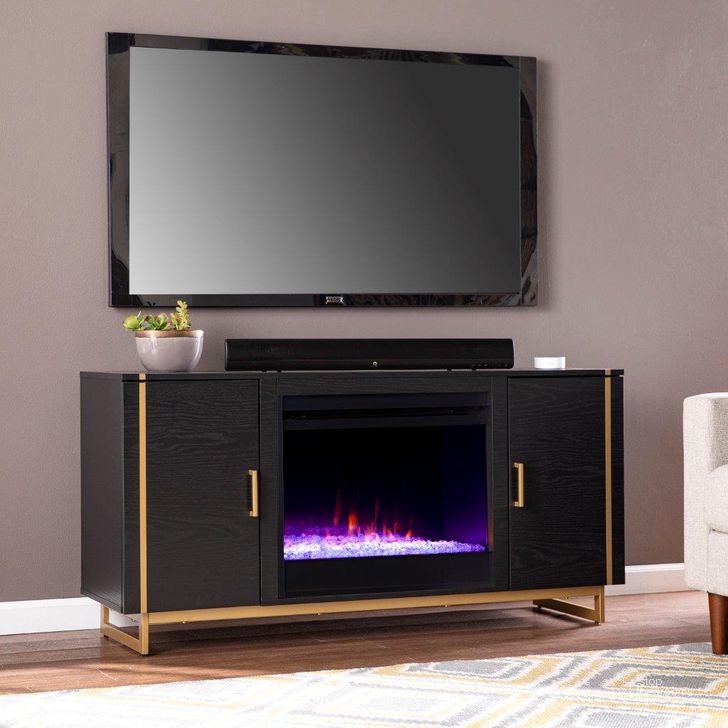 The appearance of Biddenham Color Changing Fireplace Console With Media Storage designed by SEI Furniture in the modern / contemporary interior design. This black and gold piece of furniture  was selected by 1StopBedrooms from Biddenham Collection to add a touch of cosiness and style into your home. Sku: FC1138056. Material: Wood. Product Type: Fireplace. Image1