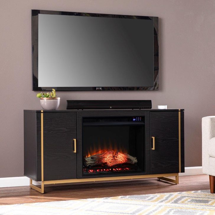 The appearance of Biddenham Electric Fireplace Console With Media Storage designed by SEI Furniture in the modern / contemporary interior design. This black and gold piece of furniture  was selected by 1StopBedrooms from Biddenham Collection to add a touch of cosiness and style into your home. Sku: FE1138056. Material: Wood. Product Type: Fireplace. Image1