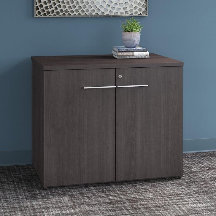The appearance of Bush Business Furniture Office 500 36W Storage Cabinet with Doors in Storm Gray designed by Bush Furniture in the modern / contemporary interior design. This gray piece of furniture  was selected by 1StopBedrooms from Office 500 Collection to add a touch of cosiness and style into your home. Sku: OFS136SGSU. Product Type: Storage Cabinet. Image1