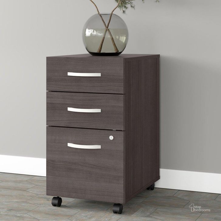 The appearance of Bush Business Furniture Studio A 3 Drawer Mobile File Cabinet in Storm Gray designed by Bush Furniture in the transitional interior design. This dark gray piece of furniture  was selected by 1StopBedrooms from Studio A Collection to add a touch of cosiness and style into your home. Sku: SDF216SGSU-Z. Product Type: Mobile Filing Cabinet. Image1