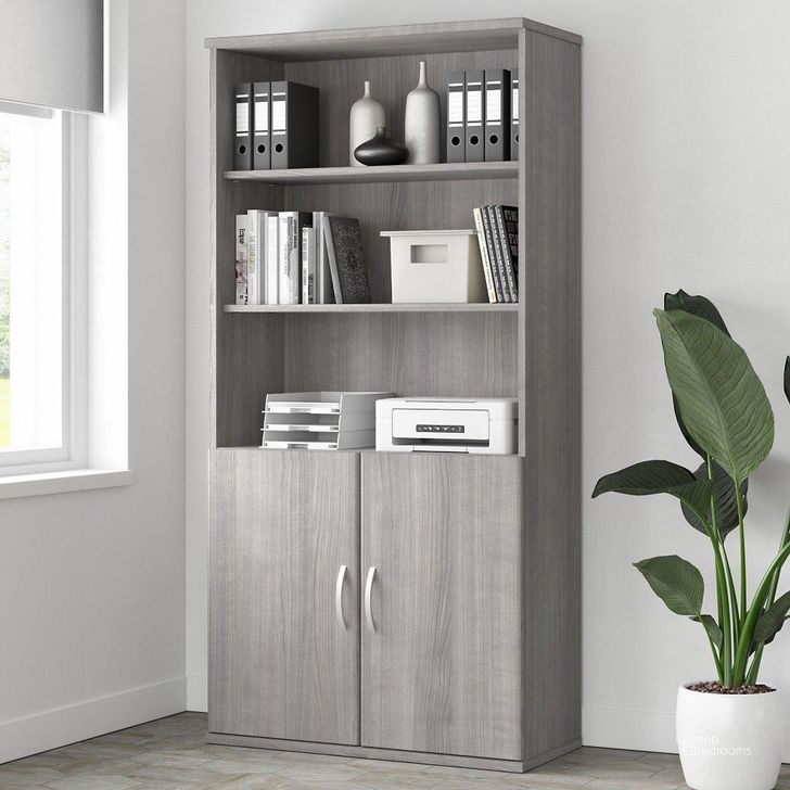 The appearance of Bush Business Furniture Studio A Tall 5 Shelf Bookcase with Doors in Platinum Gray designed by Bush Furniture in the modern / contemporary interior design. This gray piece of furniture  was selected by 1StopBedrooms from Studio A Collection to add a touch of cosiness and style into your home. Sku: STA010PG. Product Type: Bookcase. Image1