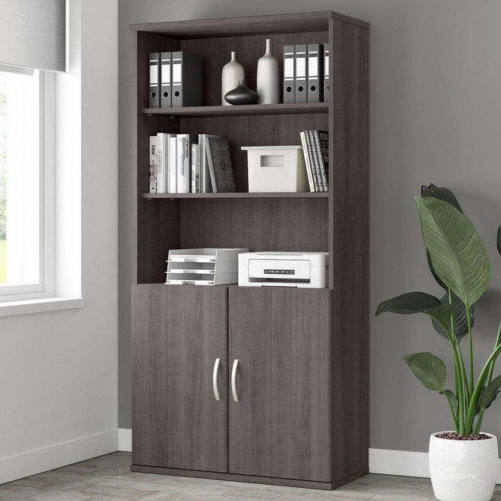 The appearance of Bush Business Furniture Studio A Tall 5 Shelf Bookcase with Doors in Storm Gray designed by Bush Furniture in the modern / contemporary interior design. This dark gray piece of furniture  was selected by 1StopBedrooms from Studio A Collection to add a touch of cosiness and style into your home. Sku: STA010SG. Product Type: Bookcase. Image1